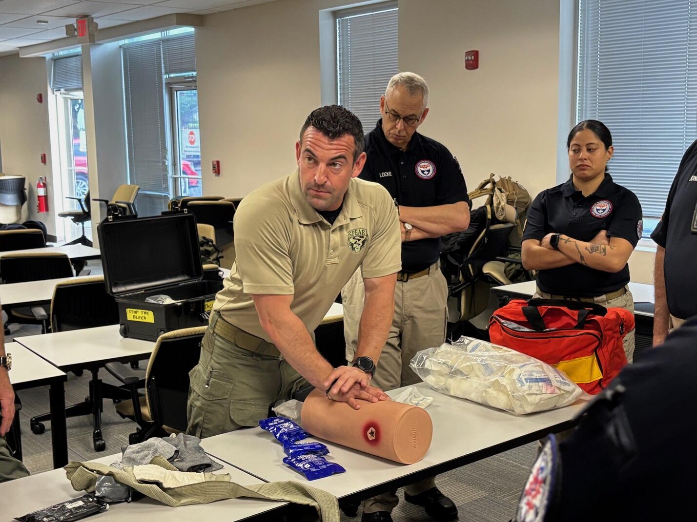Man performs CPR on demonstrative tool.