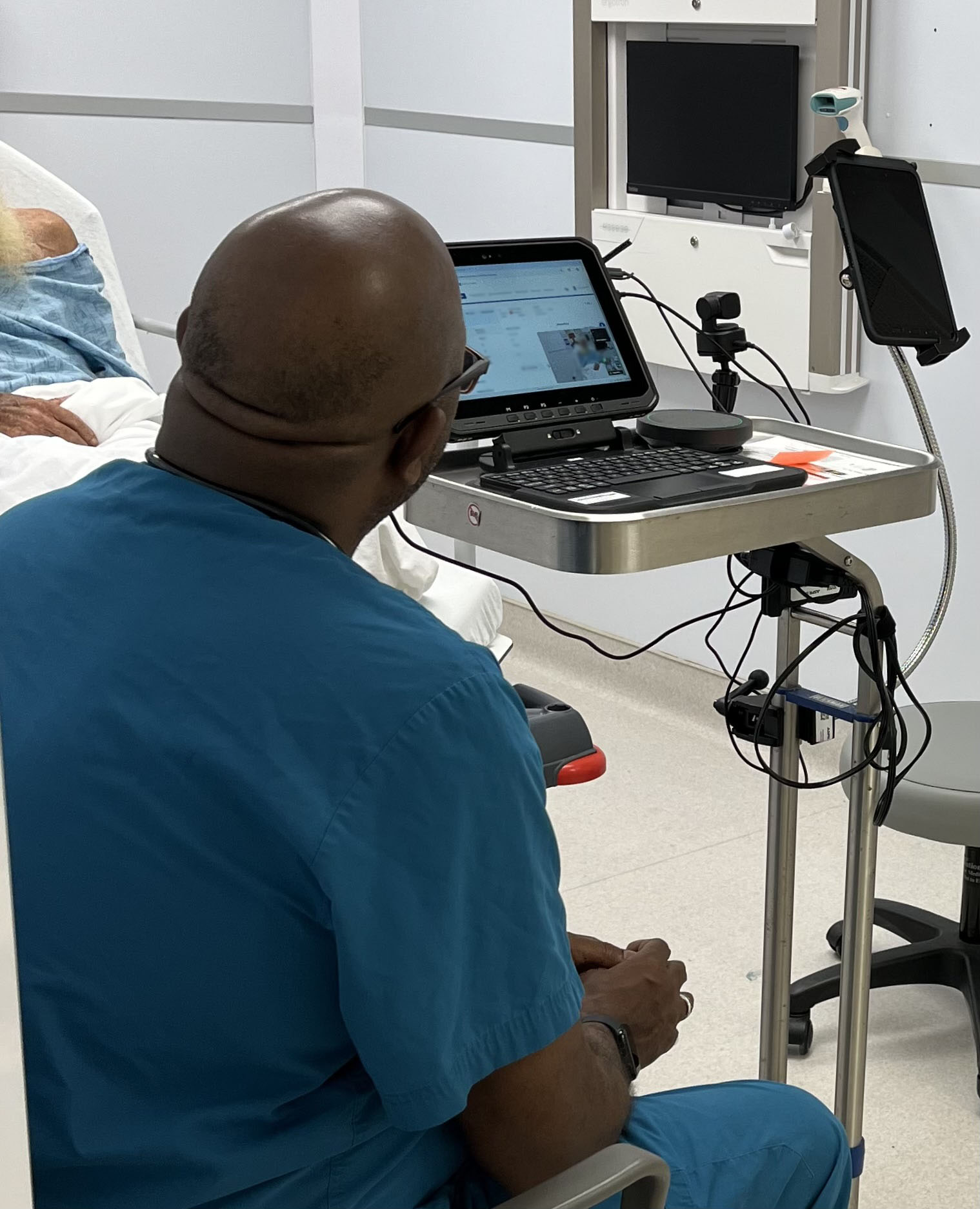 JFL ER physician observing TM Neurologist evaluating patient