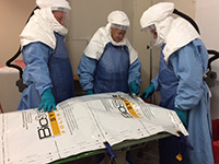 Medical personnel in protective clothing. 
