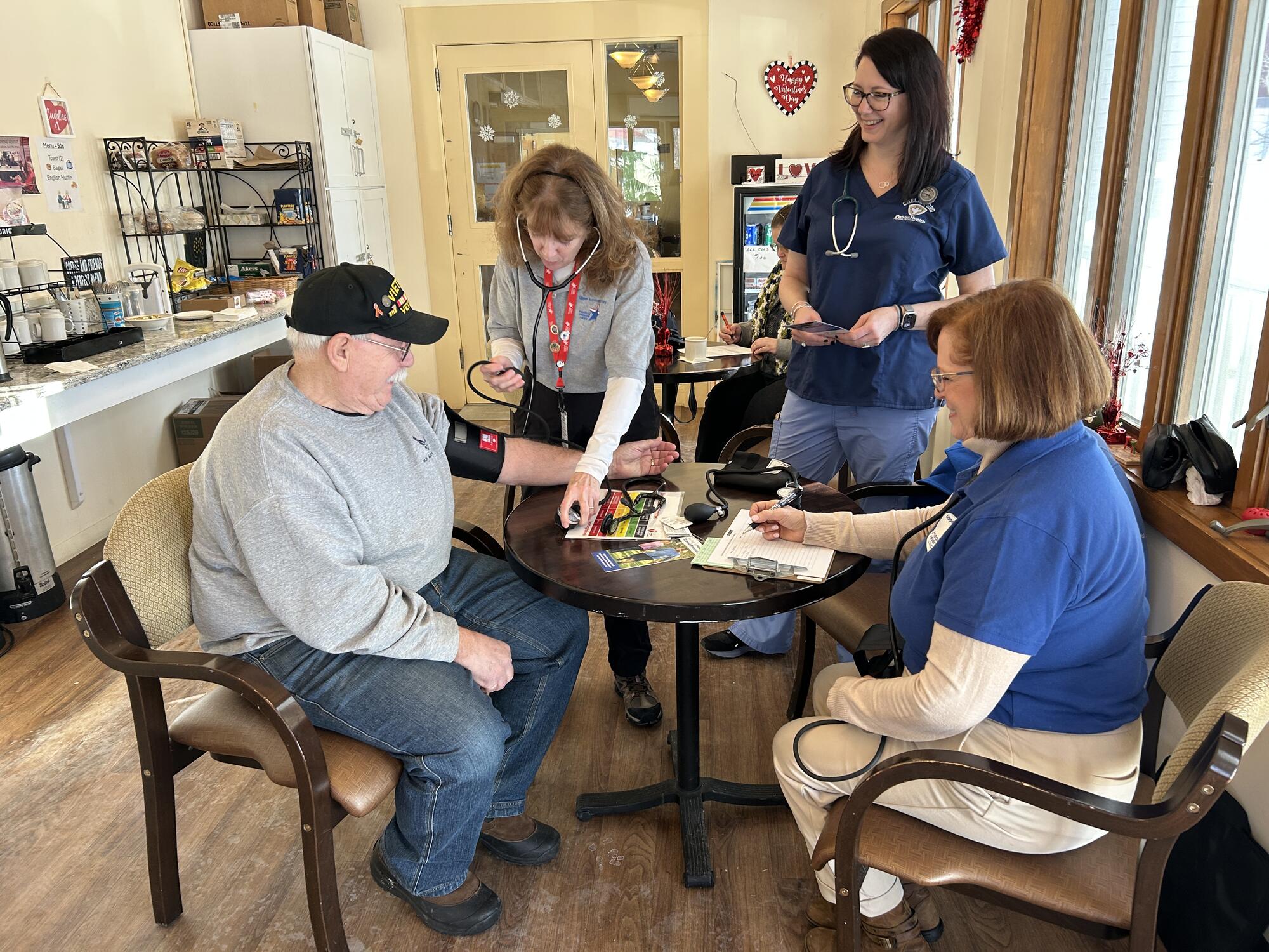 MRC volunteer taking blood pressure on resident
