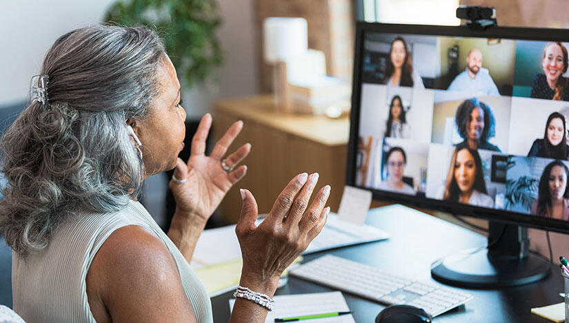 A woman talks during an online meeting