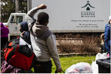Image of Gospel Mission truck delivering supplies to homeless.