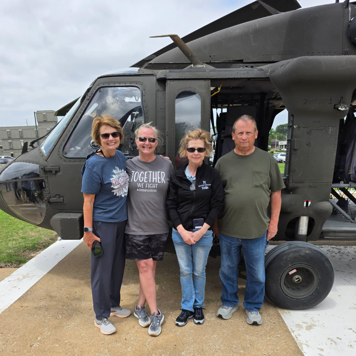 West Tennesse volunteers standing in front of a helicopter.