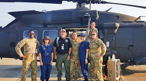 Team in front of a Helicopter