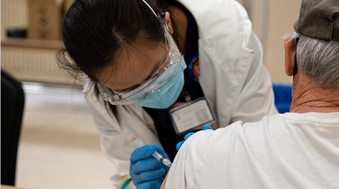 Medical Professional giving a needle to a patient. 