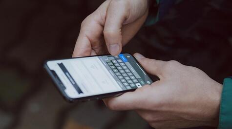 Close up of a person holding a mobile phone