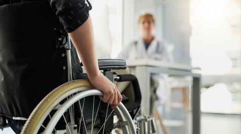 Cropped shot of an unrecognizable woman in a wheelchair visiting the doctor's rooms for a consultation