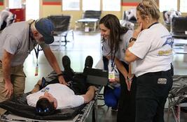 A group of people engage in a hurricane relief exercise