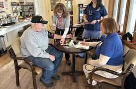 MRC taking blood pressure on a patient